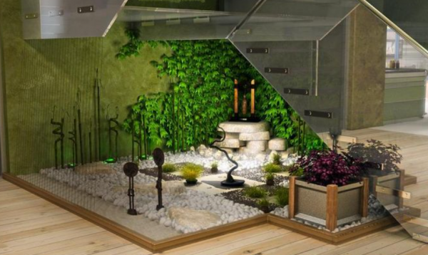 Taman dalam ruangan dengan tanaman hijau dan bebatuan alami